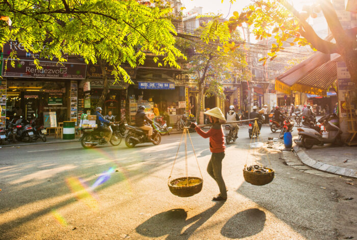The Old Quarter A vendor is walking into old street Hanoi Vietnam