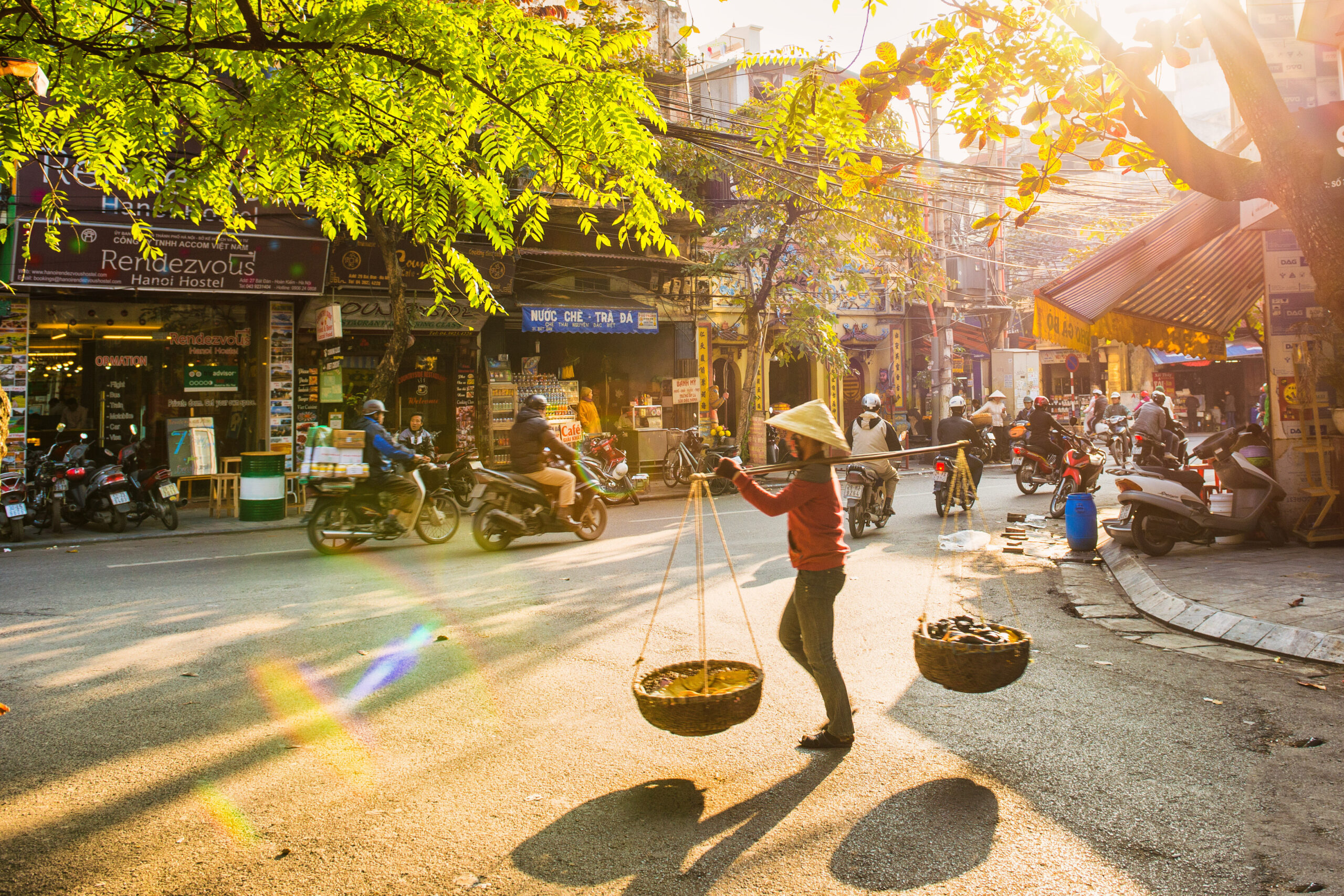 The Old Quarter A vendor is walking into old street Hanoi Vietnam scaled